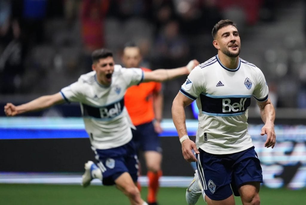 A photo of two Vancouver players celebrating a goal